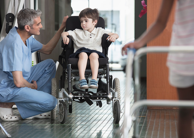 Doctor Talking to Boy in Wheelchair