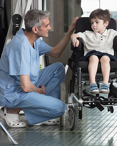 Doctor Talking to Boy in Wheelchair