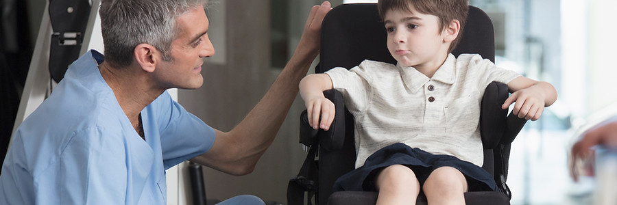 Doctor Talking to Boy in Wheelchair