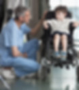 Doctor Talking to Boy in Wheelchair