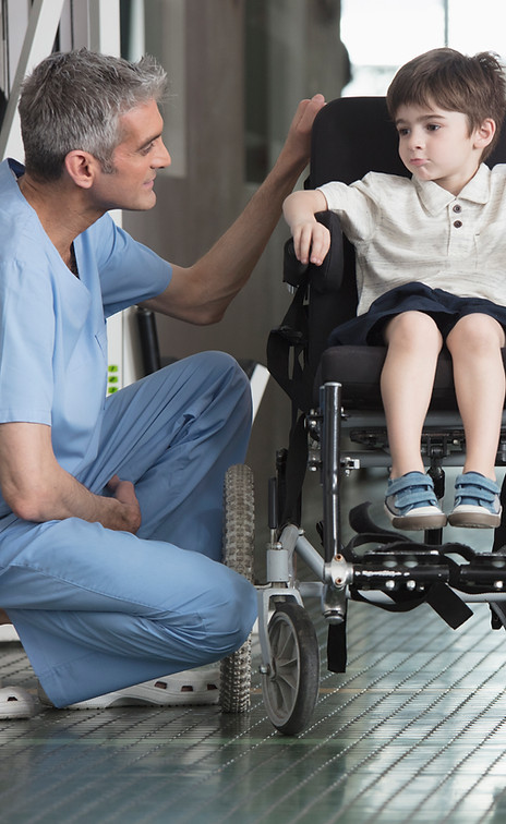 Doctor Talking to Boy in Wheelchair