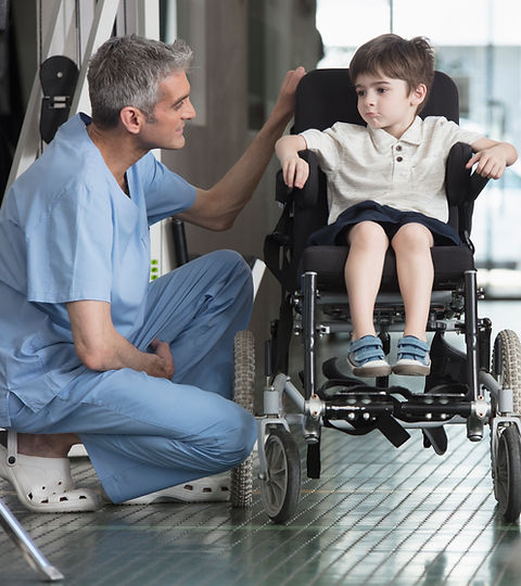 Doctor Talking to Boy in Wheelchair