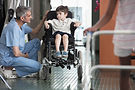 Doctor Talking to Boy in Wheelchair