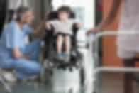 Doctor Talking to Boy in Wheelchair
