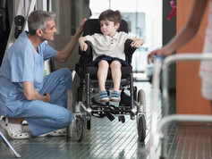 Doctor Talking to Boy in Wheelchair