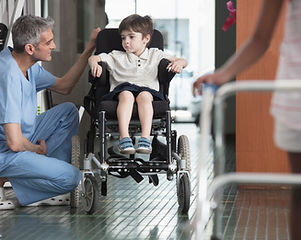 Doctor Talking to Boy in Wheelchair