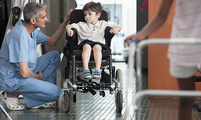 Doctor Talking to Boy in Wheelchair