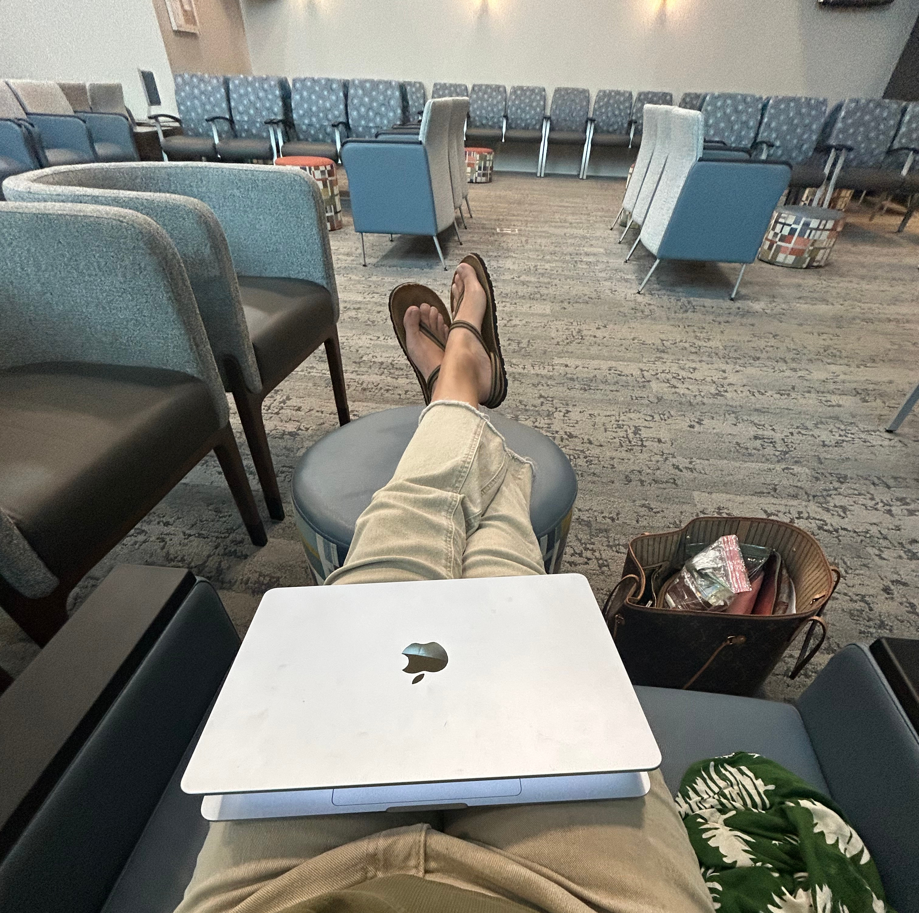 a waiting room with a computer on a person's lap