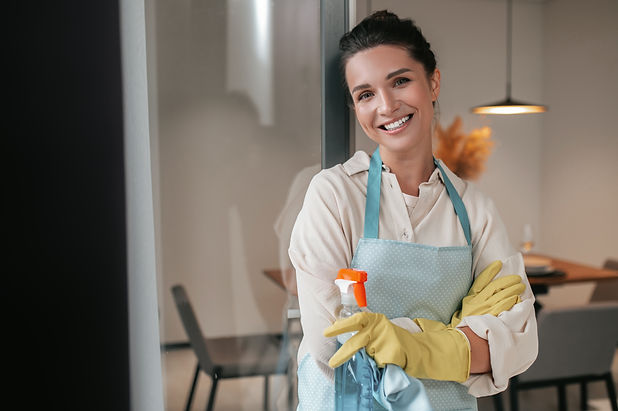 domestic-routine-smiling-housewife-apron-standing-kitchen.jpg
