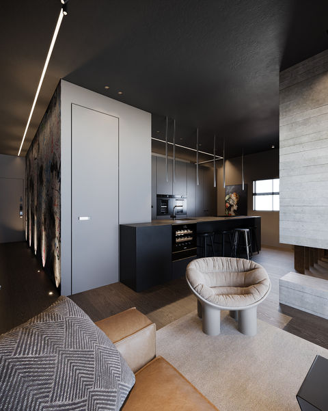 Modern apartment with dark kitchen, cozy armchair, and fireplace