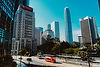 Modern Hong Kong city skyline and street with red bus