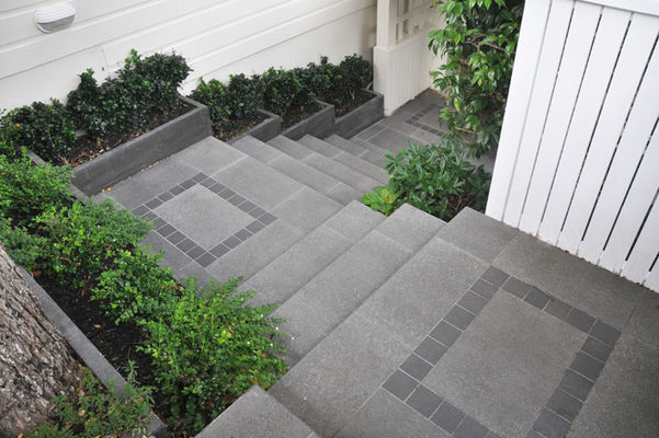 Steps down to front door with landings in bluestone granite