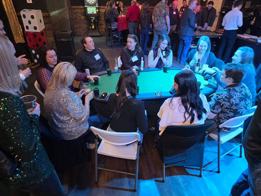 Guests playing at a poker table during a Vegas Night event.