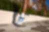 Person running in blue Hoka running shoes
