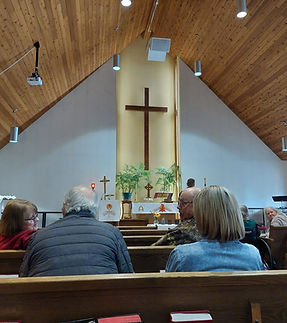 People seated in pews during a church community gathering