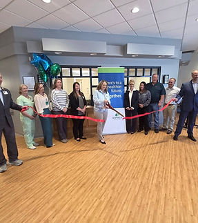 Group ribbon cutting ceremony for a community event.