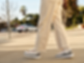 Person walking in stylish gray and white sneakers