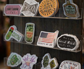 Stickers featuring 'Frickin', 'Tequila', American flag, and Grand Rapids designs.