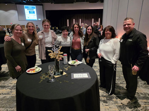 Group of attendees smiling at the annual meeting event.