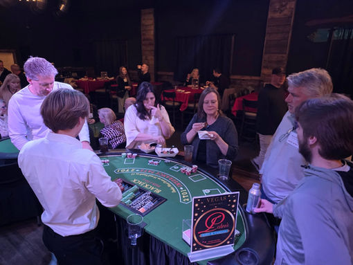 Guests playing blackjack at a Vegas Night casino event.