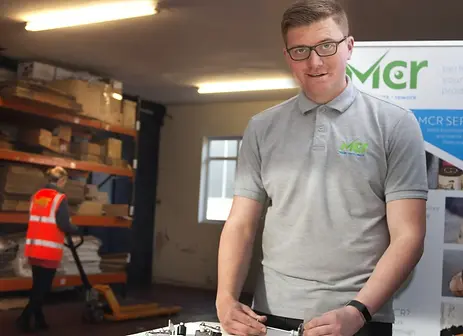 Young man standing doing rework on a product