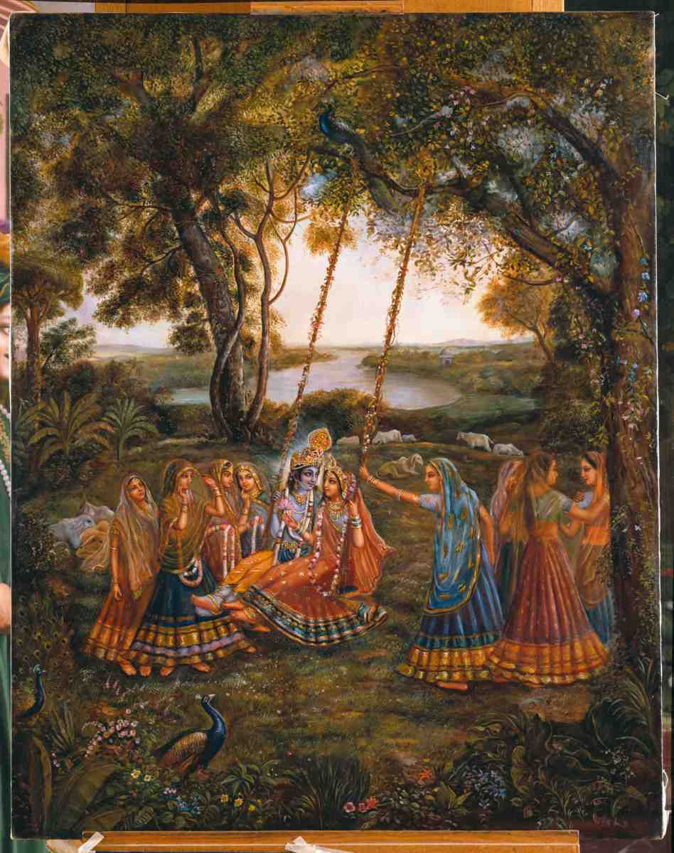 Krishna speaks with Srimati Radharani, as another gopi puts flowers in her hair