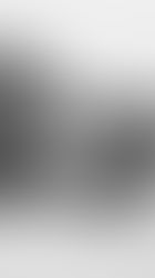 A woman laying on the ground, eyes open. Photo in black and white.