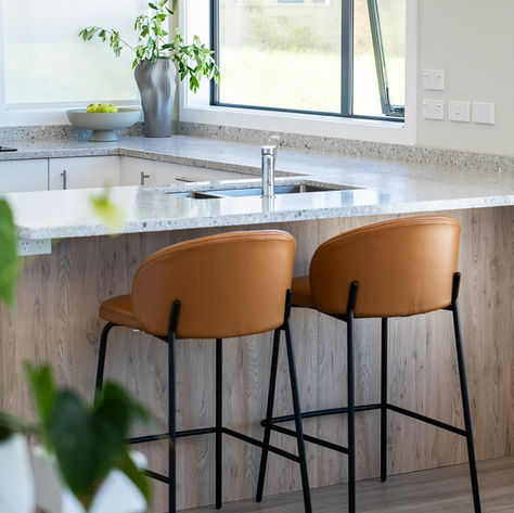 Kitchen island with tan leather bar stools