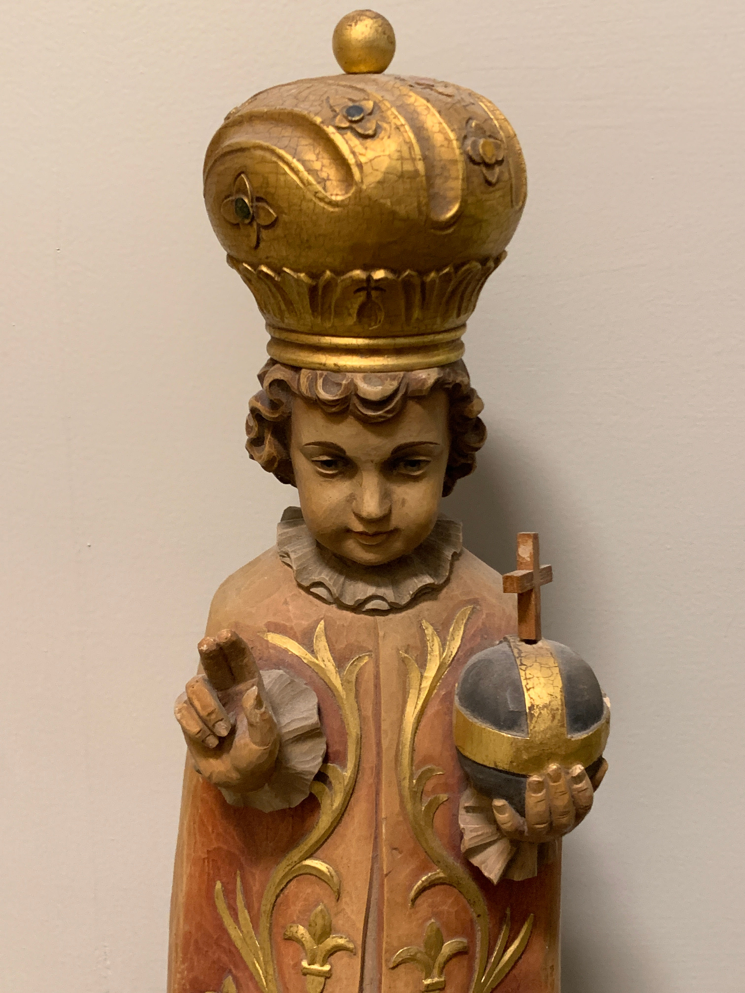 Infant Jesus of Prague hand-carved statue in red robe with golden crown, Catholic sacred artwork for church narthexes, chapel