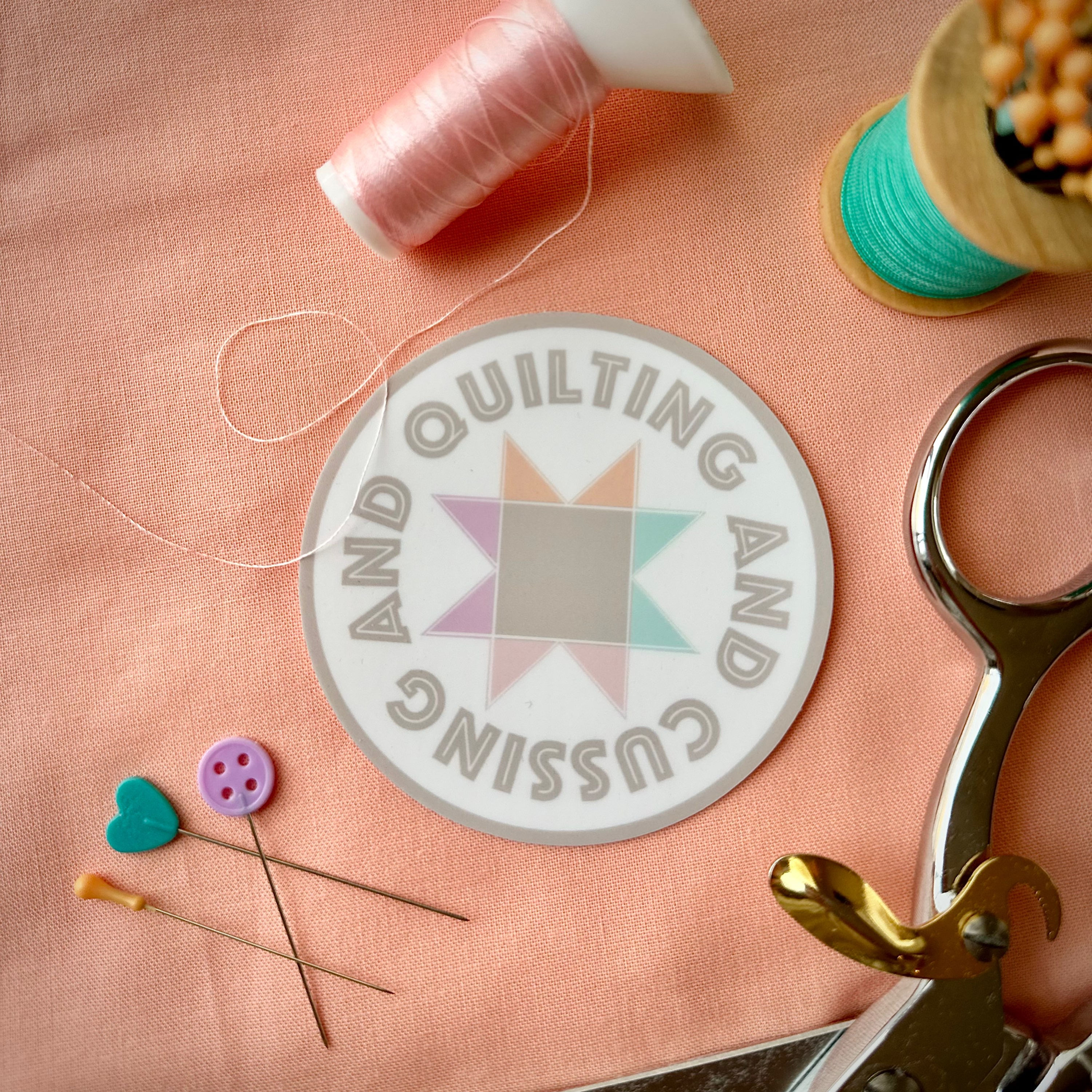 Product photo of sawtooth star in pastel colors with the words 'Quilting and Cussing' vinyl sticker. 