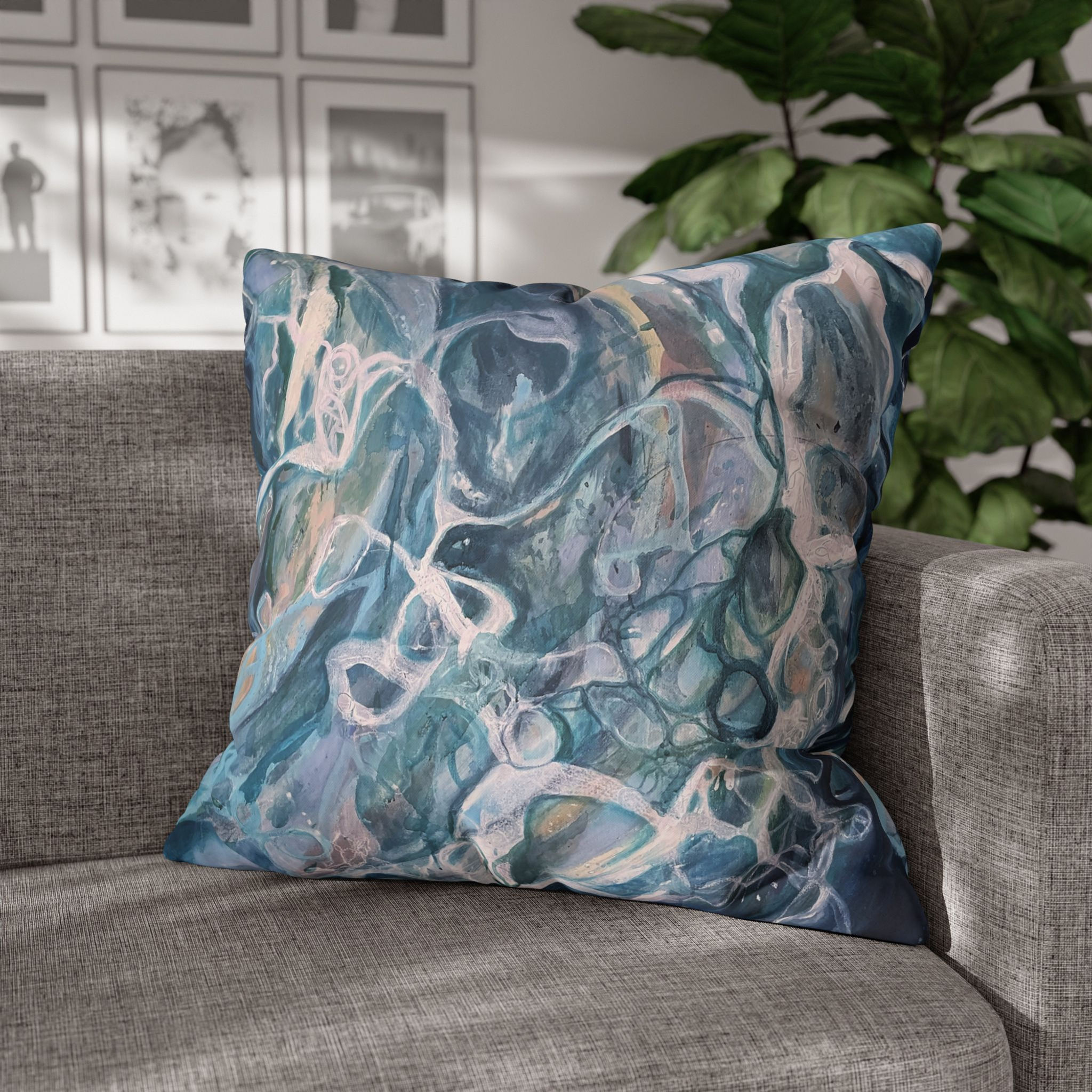 A square cushion cover printed front and back with an abstract painting, ocean-inspired swirl of teal, indigo, & foamy water