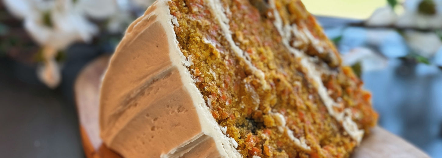 large slice of carrot cake with frosting