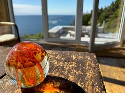View of the deck and ocean from the living room of SeaSky Cottage