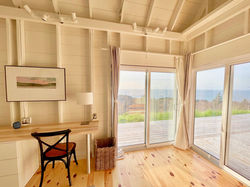 desk and chair in the bedroom allow remote work, while still enjoying stunning views of the ocean
