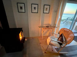 Cozy by the fire;  enjoy the living room wood stove