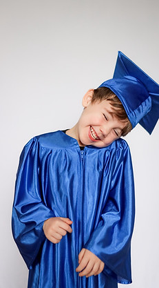 Yearbook photo of a Beyond the Books Academy (BTBA) student smiling in school cap and gown.