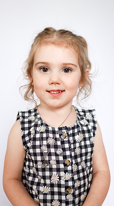 Yearbook photo of a Beyond the Books Academy (BTBA) student smiling in gingham shirt.