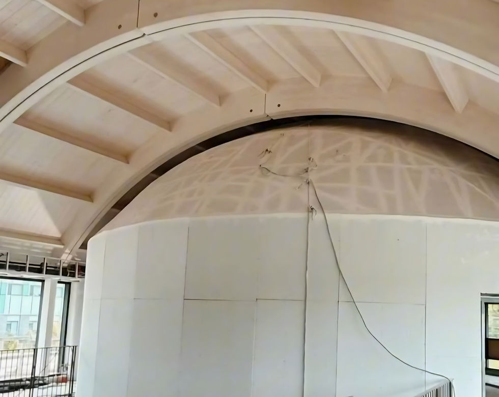 Arch drywall installation in university facility.