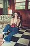 Singer in front of vintage couch holding a rotary phone