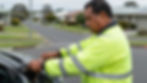 Tow truck operator working on a car