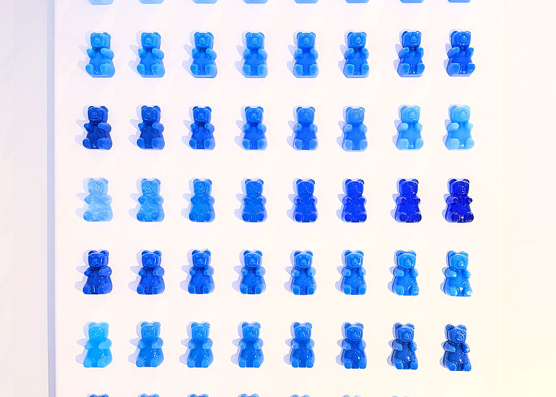 Ombre blue gummy bears on canvas
