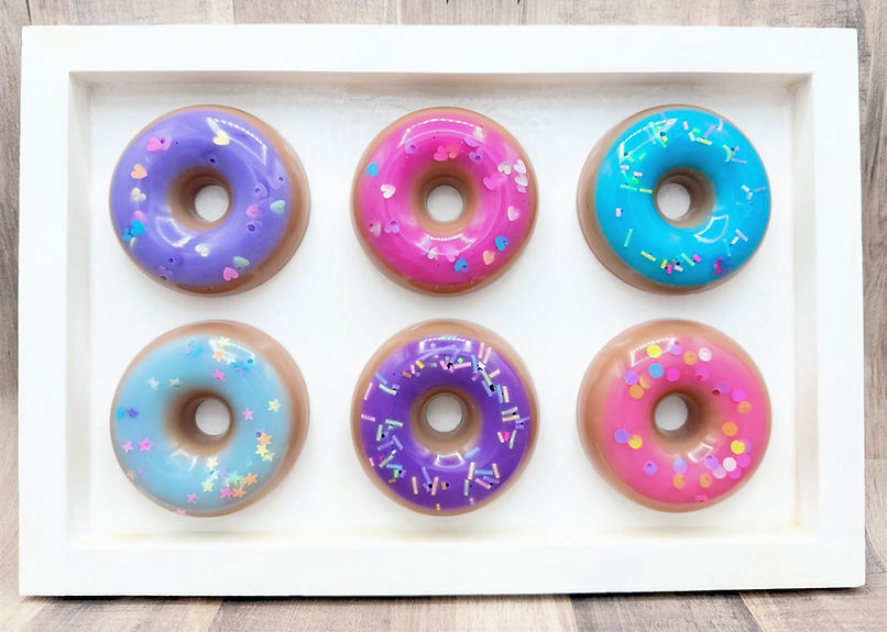 Resin donuts with confetti sprinkles in pink, blue and purple