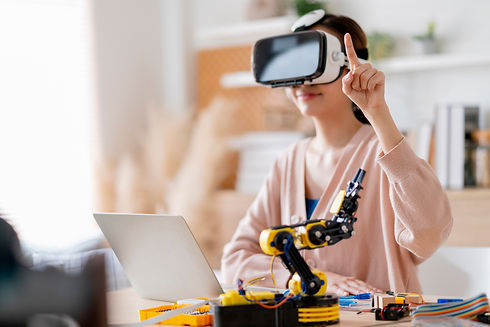 smart-asian-female-programer-wear-vr-control-learning-robot-arm-ai-coding-electronic-board