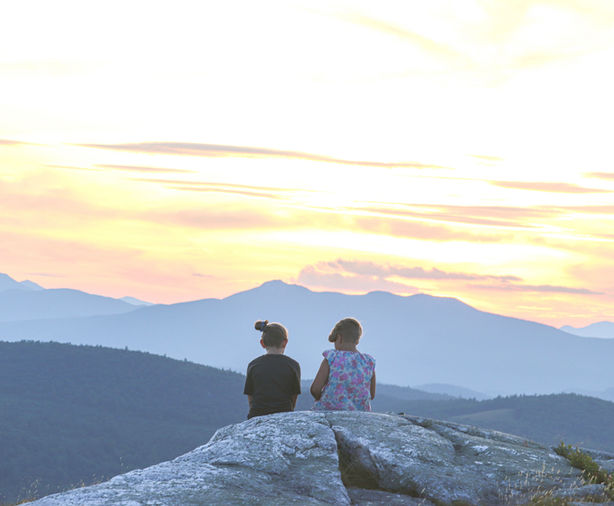 Girls on a mountaintop at sunset for family portrait session