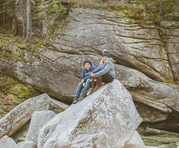 Brother and sister on a boulder, riverside for family portrait session