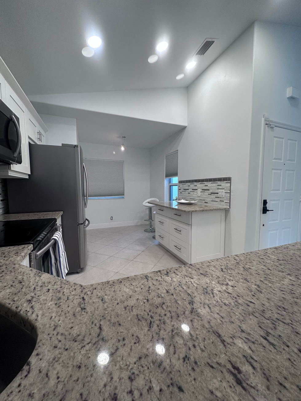 "Kitchen after construction cleaning showing gleaming countertops and polished appliances."