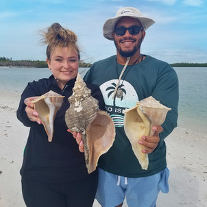 Marco Island Shelling Boat Tour Guests find HUGE Horse Conch
