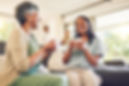 woman-drinking-cup-coffee-with-her-senior-mother-while-laughing-talking-bonding-home-happy