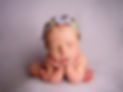 Image of newborn baby girl posed in "froggy" pose on lilac backdrop wearing lilac headband by Specialist Newborn Photographer, Hull and East Yorkshire and North Lincolnshire