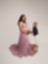 Photo of mum to be and her little boy. Mum is wearing mauve gown and little boy a blue shirt and cream trousers by East Yorkshire and Hull Maternity Photographer 